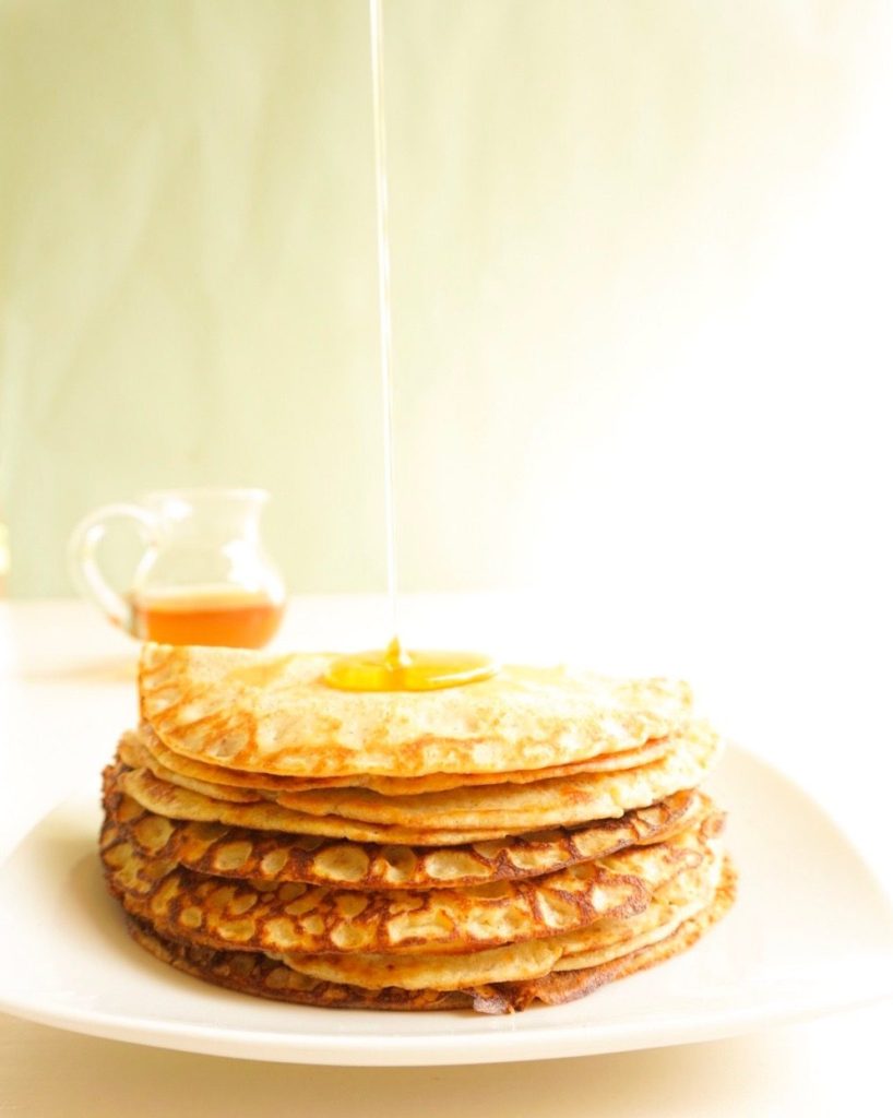 pouring syrup on pancakes
