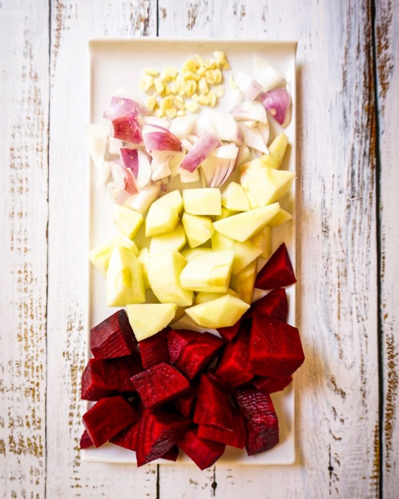 Healthy ingredients of beetroot soup cubed; beetroot, apple, red onion and garlic