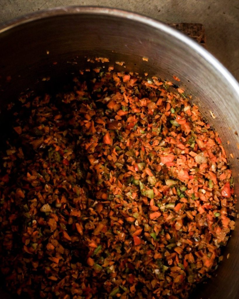 veggies cooking down in a stockpot