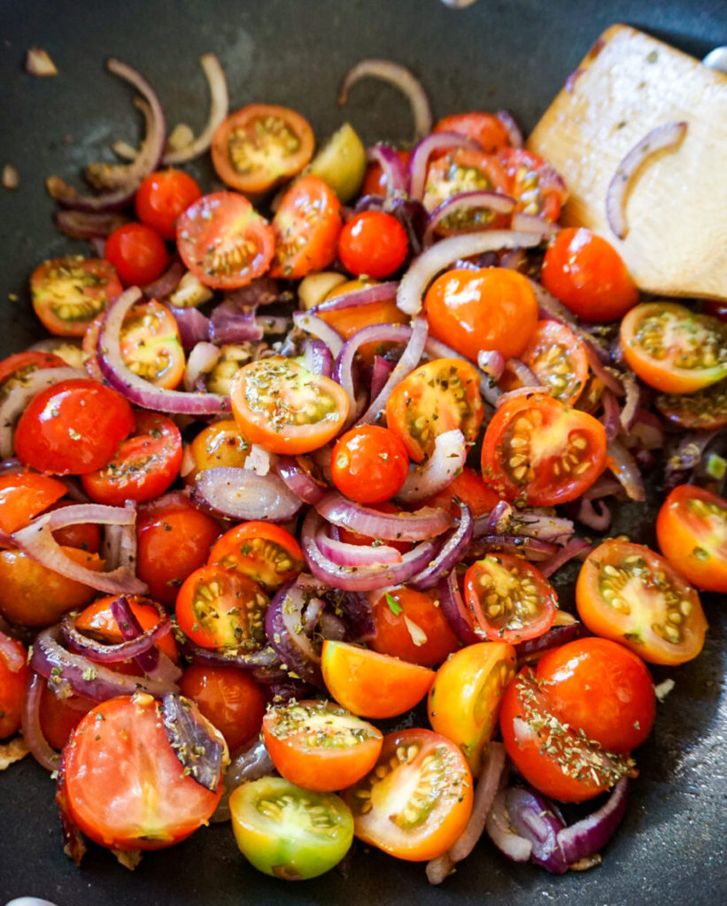 tomatoes and onions in skillet