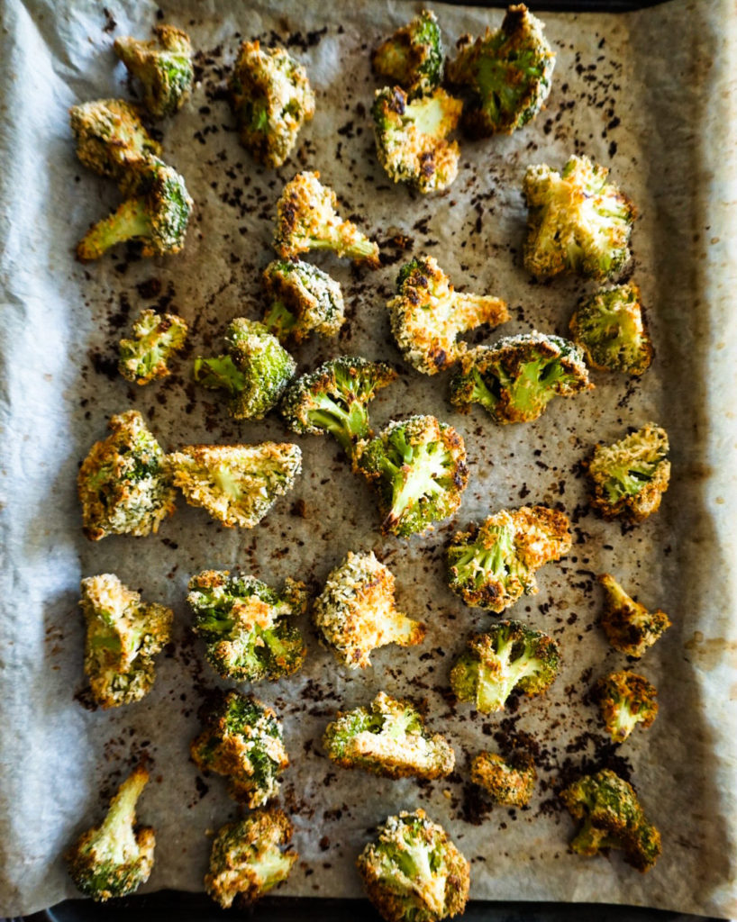 baked broccoli on a baking sheet just out of the oven