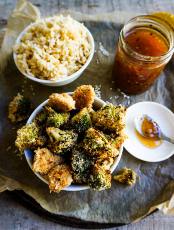 chicken, a bowl of rice and a jar of sweet chili sauce close up