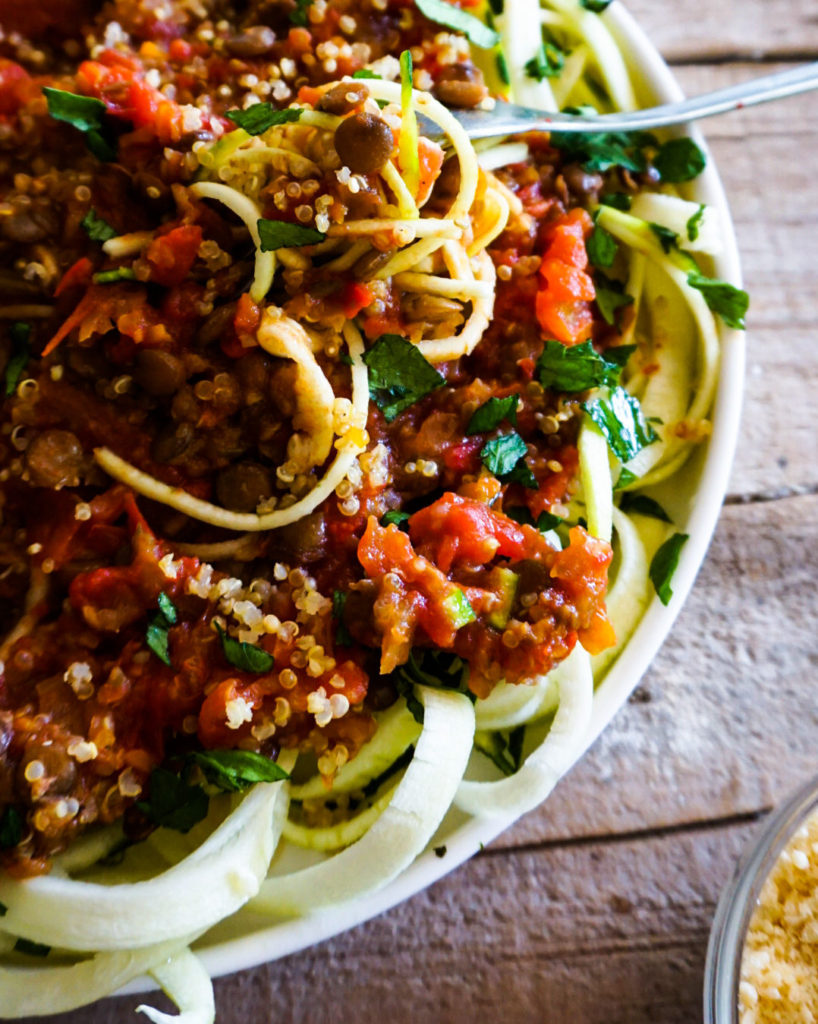 close up of lentil quinoa sauce and zucchini noodles