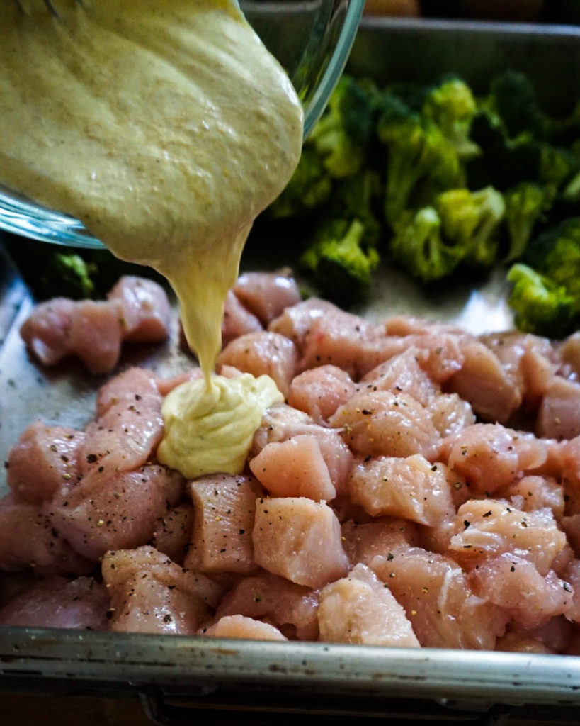 pouring marinate over chicken