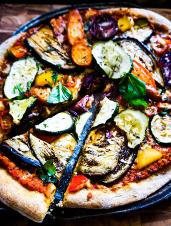 a slice of roasted veggies pizza