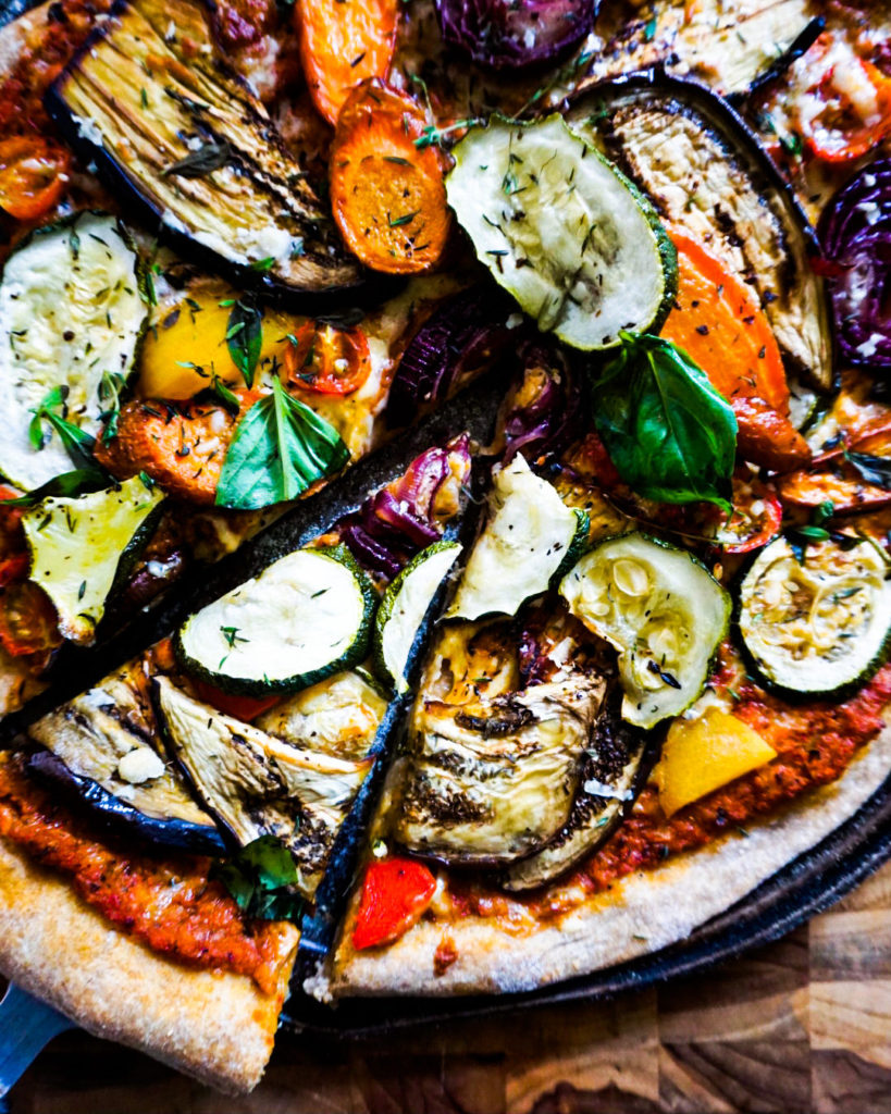 a slice of roasted veggies pizza