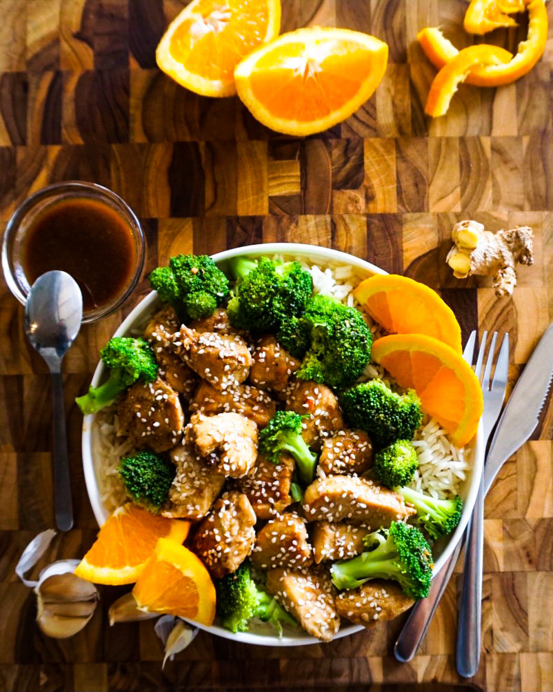 orange ginger chicken and broccoli with extra sauce on the side