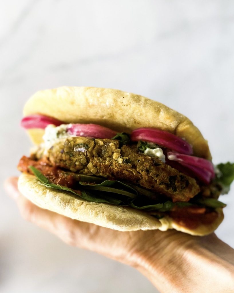falafel naan burger in hand close up