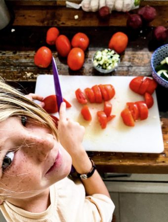 Cooper cutting tomatoes and cucumbers