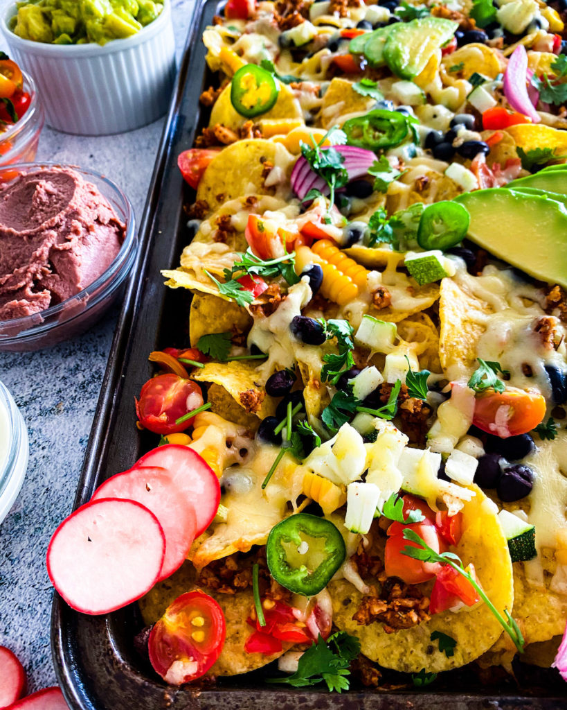 close up of summer nachos with all the sides 