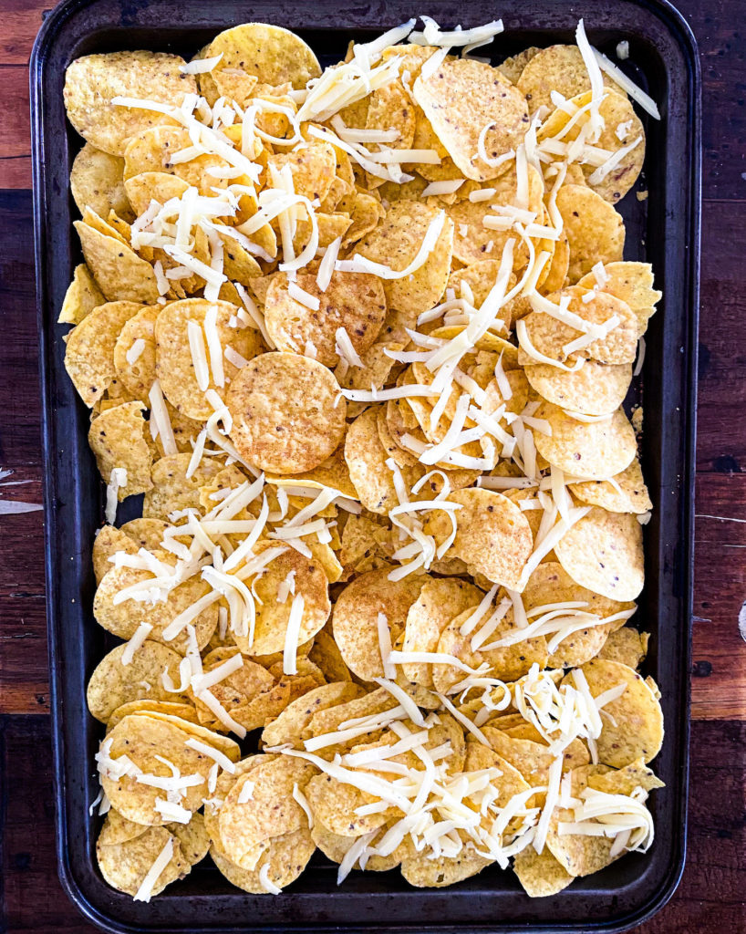 tortilla chips and cheese on a baking tray