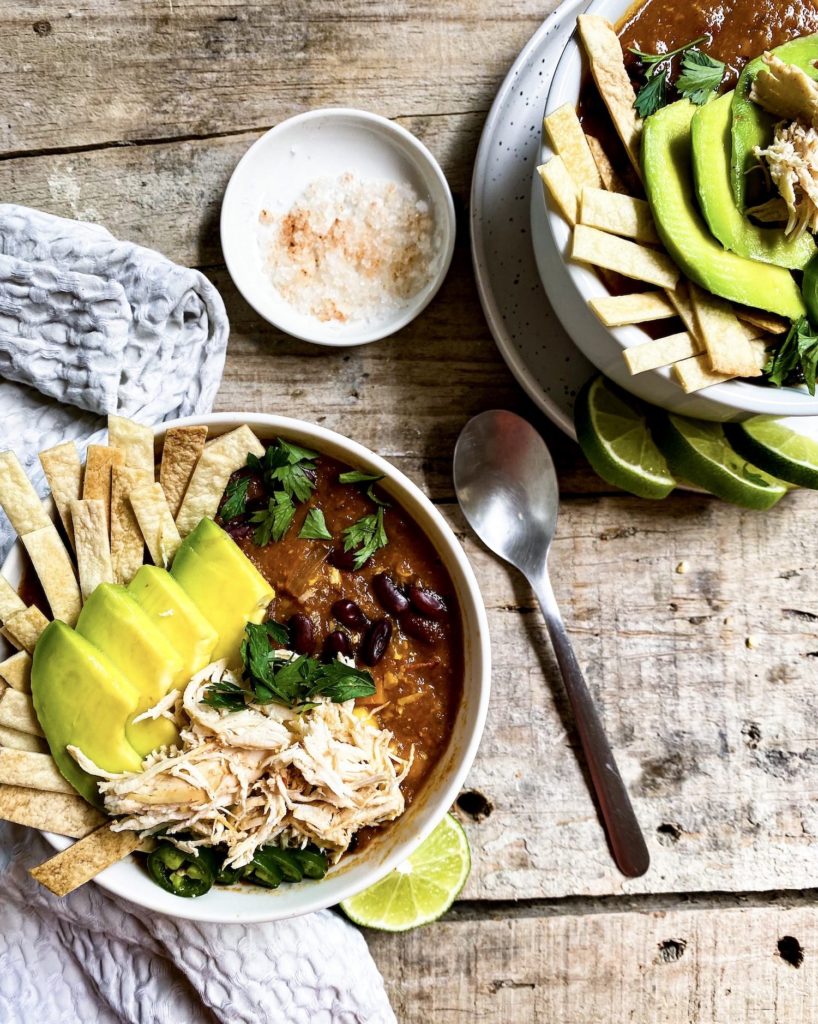 two bowls of tortilla soup with garnishing