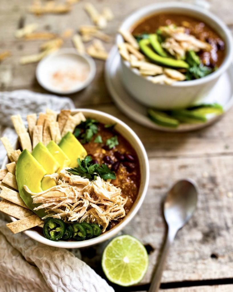 two bowls of tortilla soup with garnishing