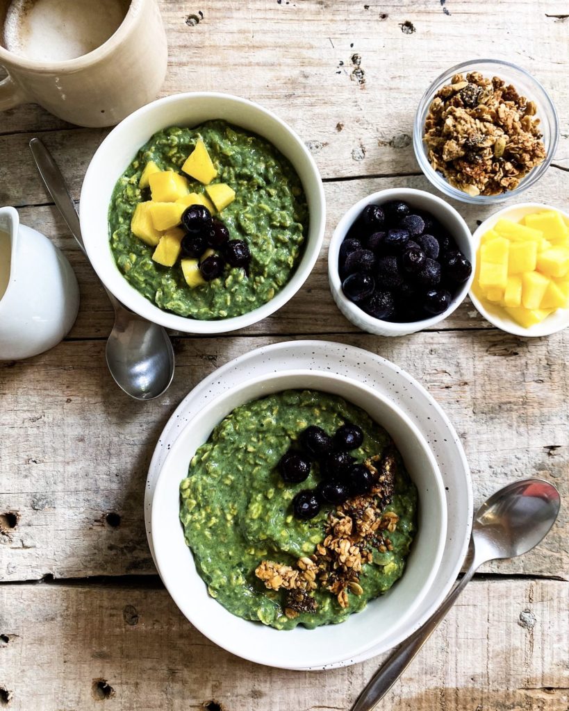 green goddess overnight oats divided over bowls with toppings on the side