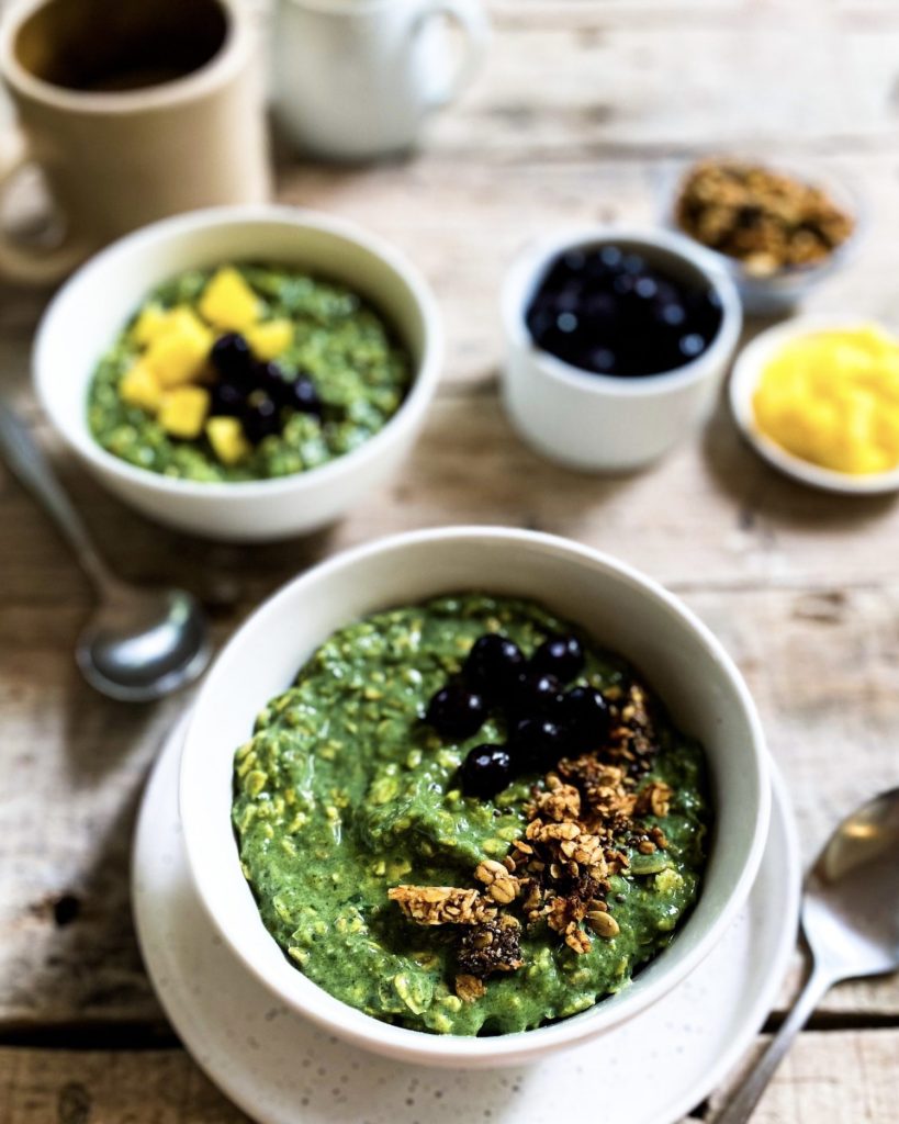 green goddess overnight oats divided over bowls with toppings on the side