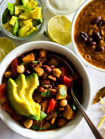 2 bowls of chili with garnishing on the side
