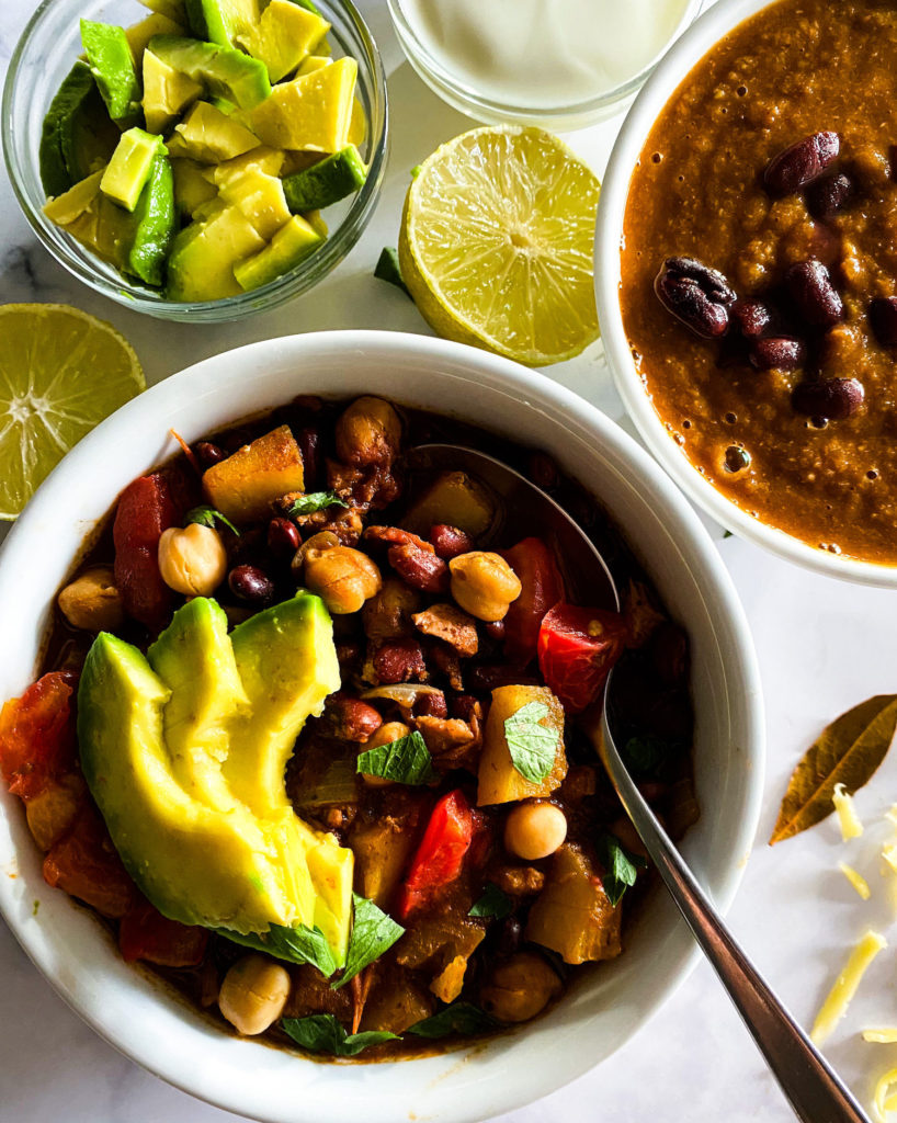 2 bowls of chili with garnishing on the side