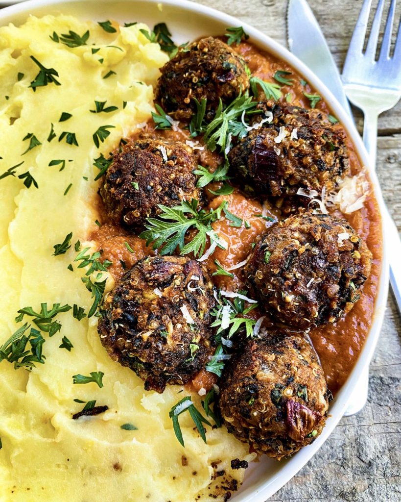 close up of a plate of vegan meatballs in tomato sauce
