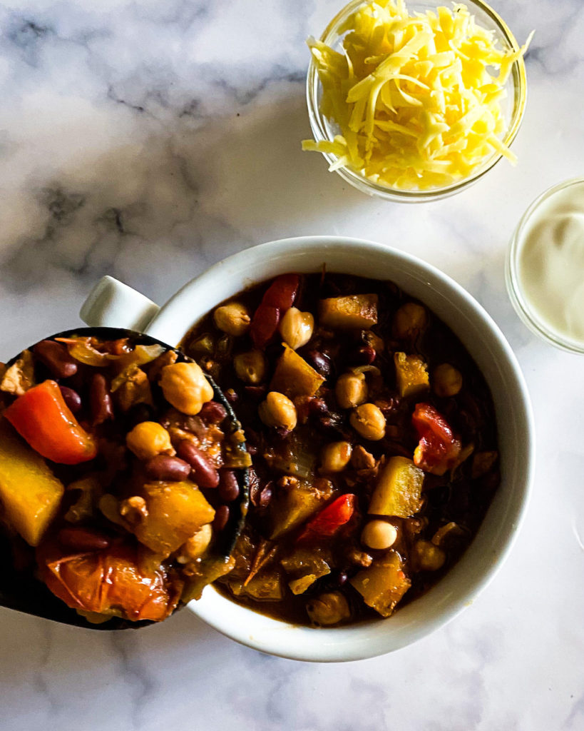 scooping chili in a bowl
