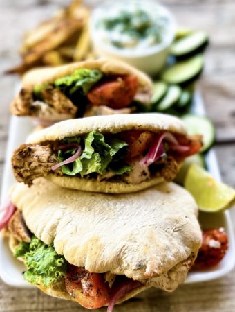 Lemon marinated chicken pitas with oven baked fries and tzatziki