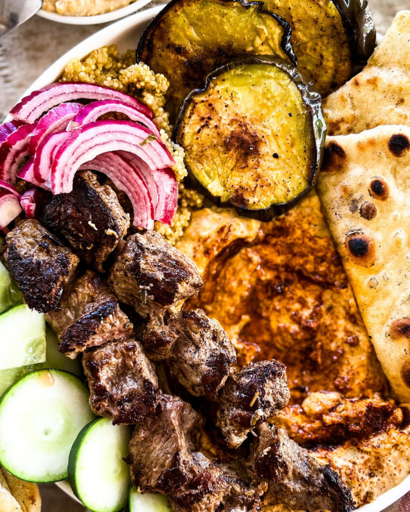 close up of a souvlaki hummus bowl