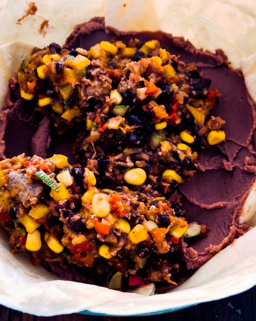 adding the taco filling to the pie