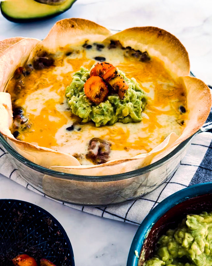 taco pie with guacamole and cherry tomatoes