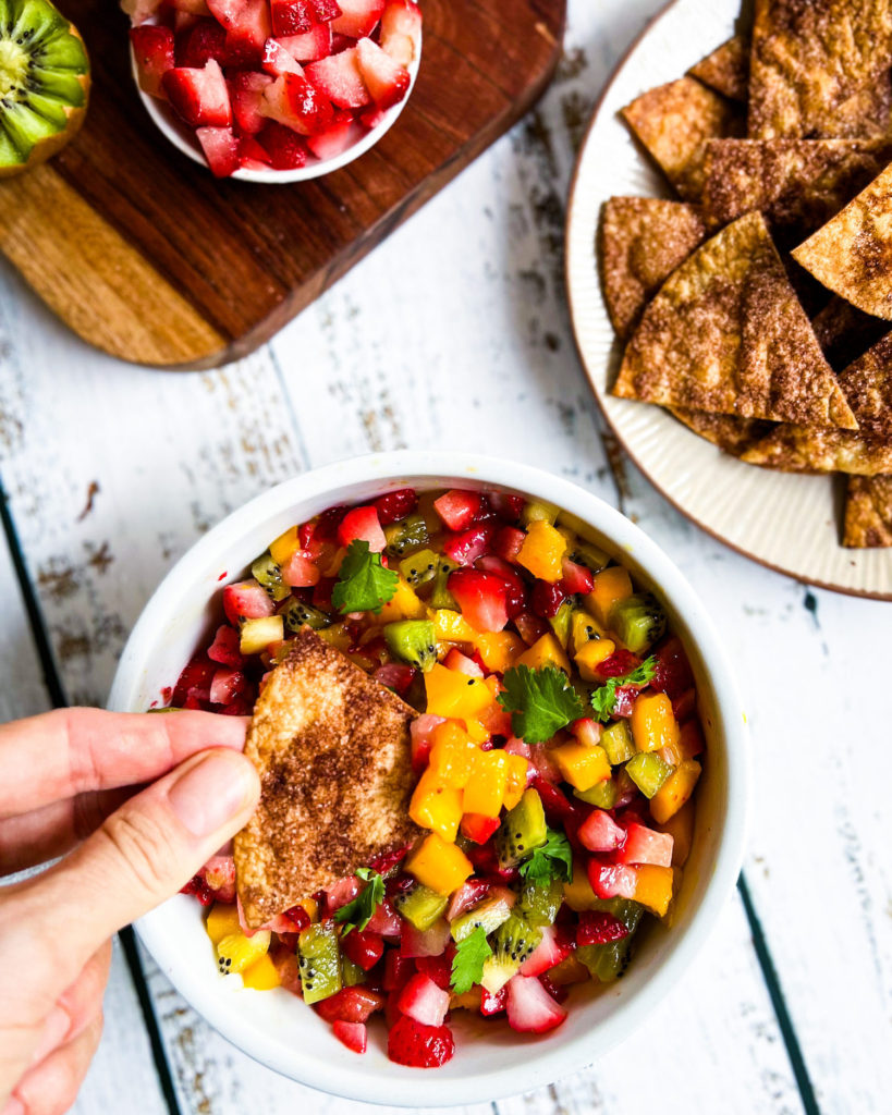 scooping up fruit salsa with cinnamon sugar chips