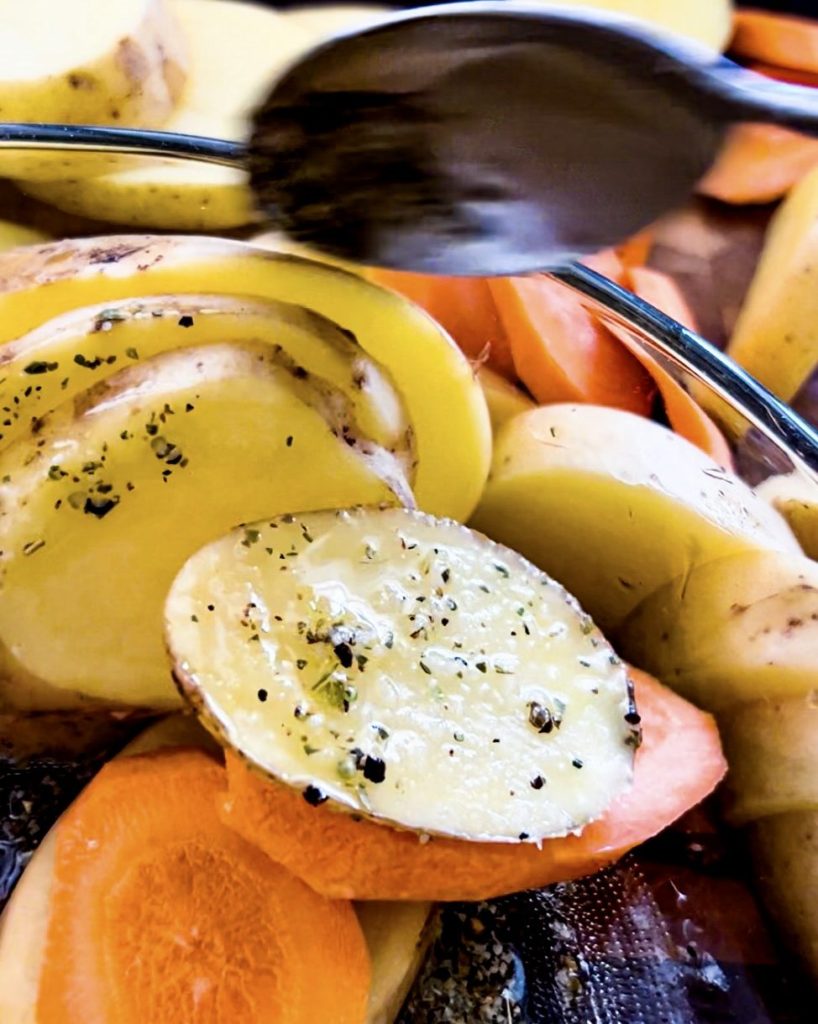 adding potatoes and carrots to the marinate