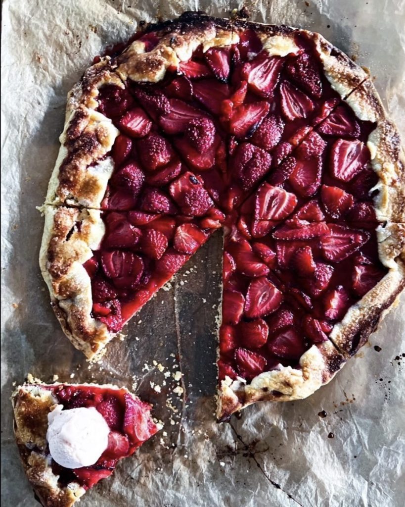 Slice of galette with a scoop of ice cream on it