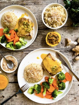 2 plates of fish with passionfruit sauce, veggies and rice close up
