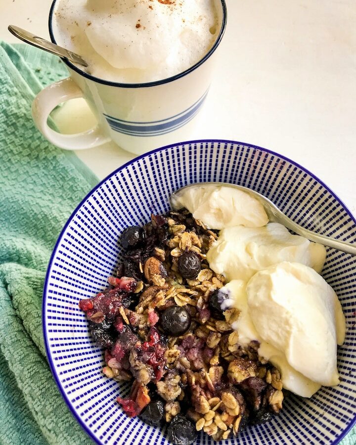blueberry bake in bowl with yogurt and cappuccino on the side